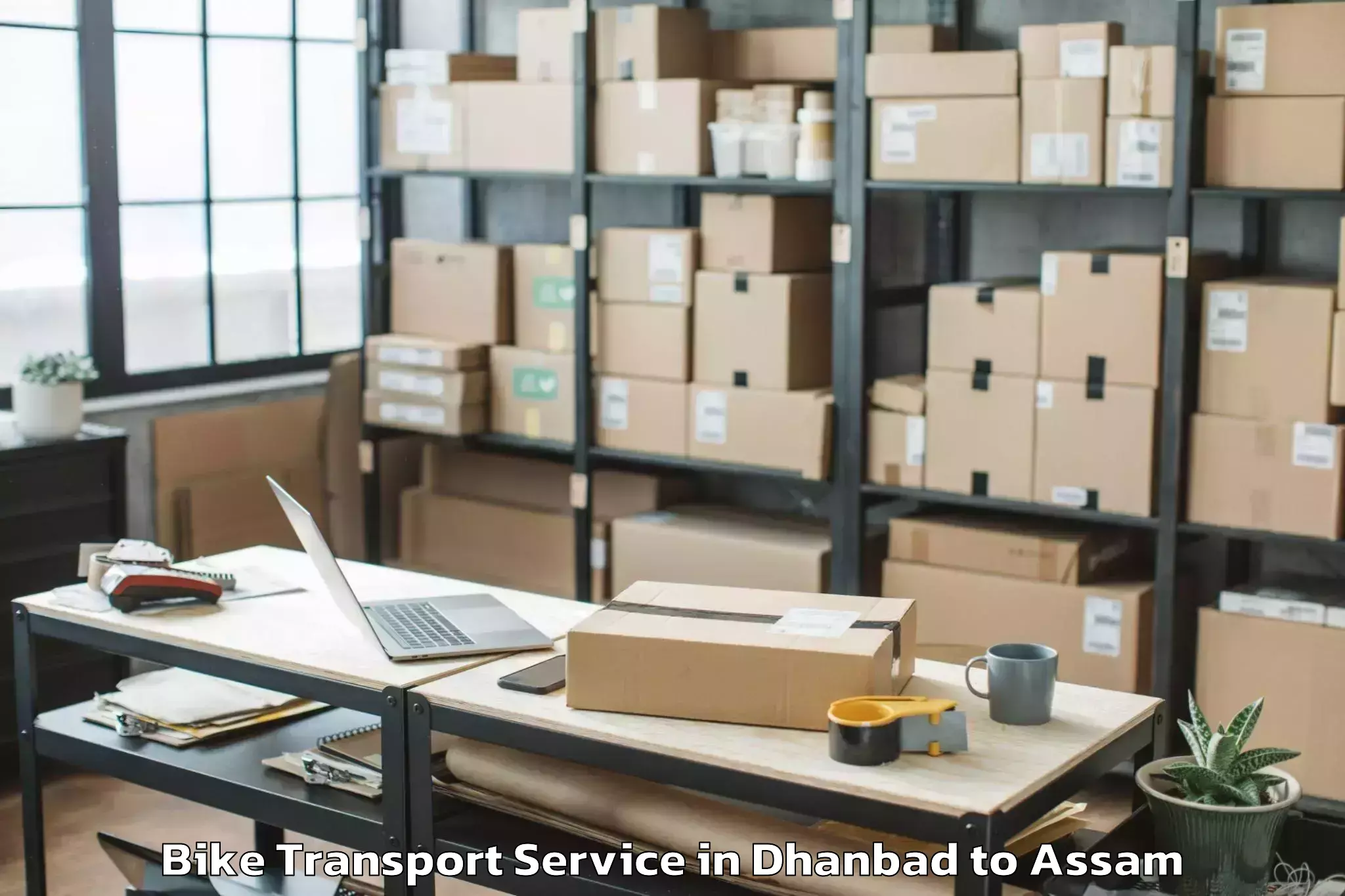 Dhanbad to Marigaon Bike Transport Booking